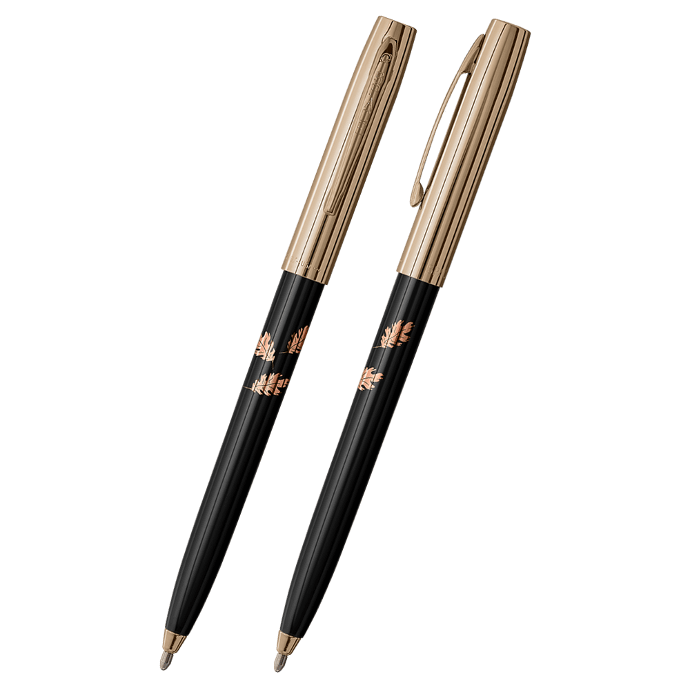 Front and side views of cap-o-matic space pen with black plastic barrel, gold colored cap with clip, gold colored tip, and imprinted copper leaves.
